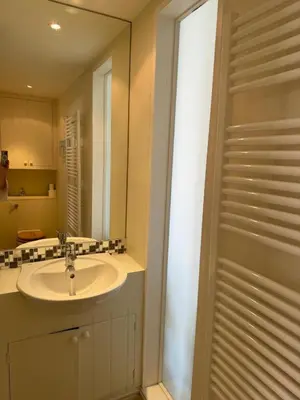 a bathroom with a sink and a mirror at Regents House, ground floor apartment with sea views in Moffat