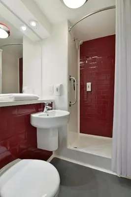 a bathroom with a toilet and a sink and a shower at Travelodge Carlisle Central in Carlisle