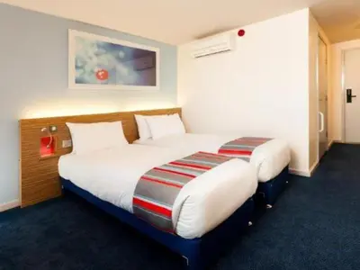 a hotel room with two beds in a room at Travelodge Carlisle Central in Carlisle