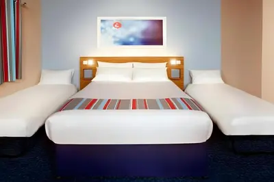 two twin beds in a hotel room at Travelodge Dumfries in Collin