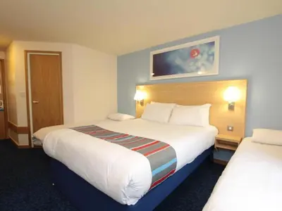 a hotel room with two beds at Travelodge Carlisle Todhills in Rockcliffe