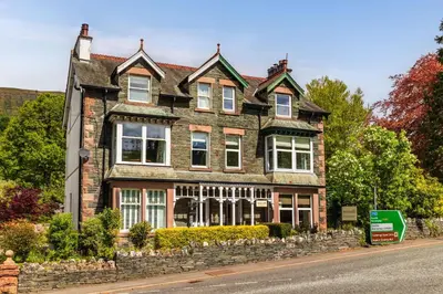 a large brick house on the side of a street at Woodside B & B in Keswick