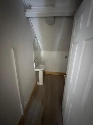 a small bathroom with a sink and a mirror at 9-11 London Road, Carlisle, CA12JU in Carlisle