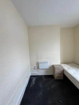 an empty room with a bench and a heater at 9-11 London Road, Carlisle, CA12JU in Carlisle
