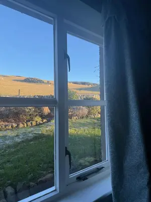 a window with a view of a field at Skinnel Cottage in Kirkcudbright