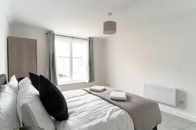 a bedroom with a bed and a window at Bright 1 Bed Harbour-side Apartment in Whitehaven in Whitehaven