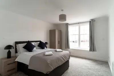 a bedroom with a large bed and a window at Bright 1 Bed Harbour-side Apartment in Whitehaven in Whitehaven