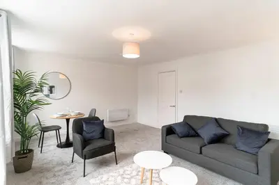 a living room with a couch and a table at Bright 1 Bed Harbour-side Apartment in Whitehaven in Whitehaven