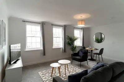 a living room with a couch and a table at Bright 1 Bed Harbour-side Apartment in Whitehaven in Whitehaven