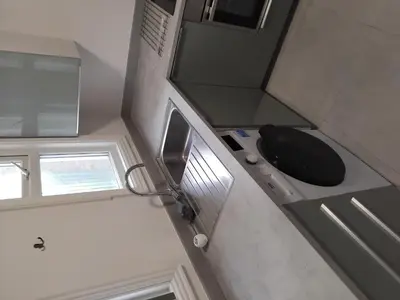 a bathroom with a black toilet and a sink at Double rooms in Moffat