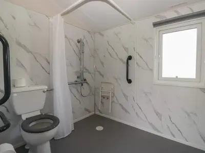 a bathroom with a toilet and a window at Guillemot in St Bees