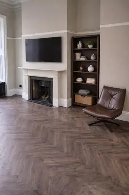 a living room with a chair and a fireplace at Carlisle City Centre Fabulous Georgian townhouse in Carlisle