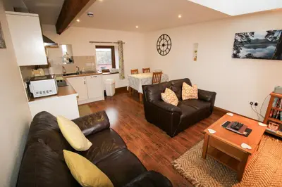 a living room with a couch and a table at Milecastle, Irthington on Hadrians Wall in Irthington