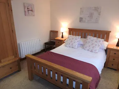 a bedroom with a bed with two night stands and two lamps at Stanegate, Irthington on Hadrians Wall in Irthington