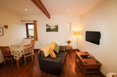 a living room with a couch and a table at Turret, Irthington on Hadrians Wall in Irthington