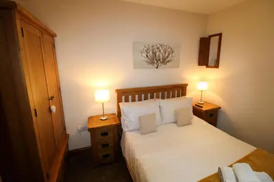 a bedroom with a bed and two lamps on tables at Turret, Irthington on Hadrians Wall in Irthington