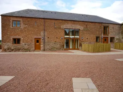 a brick building with a courtyard in front of it at Turret, Irthington on Hadrians Wall in Irthington