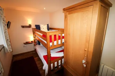 a small room with a bunk bed and a door at Vallum, Irthington on Hadrians Wall in Irthington