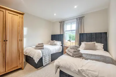 a bedroom with two twin beds and a window at 2 Bed in Gretna Green oc-n34146 in Gretna Green