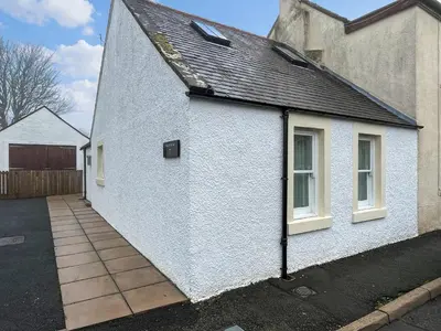 a white house with a black roof at Taigh-Beag - Uk50660 in Wigtown