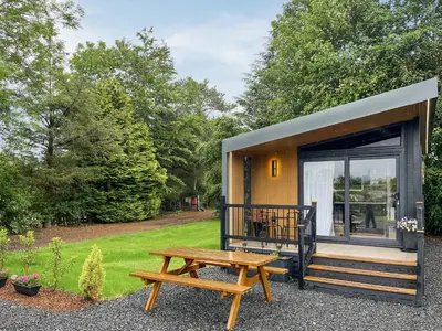 a tiny house with a picnic table and a bench at Blencathra View - Uk50085 in Penruddock