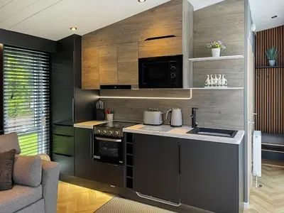 a kitchen with a stove and a microwave at Blencathra View - Uk50085 in Penruddock