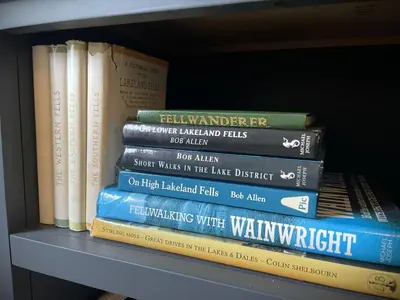 a stack of books sitting on a shelf at Catbells in Keswick