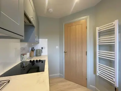 a kitchen with a door leading into a kitchen at Catbells in Keswick
