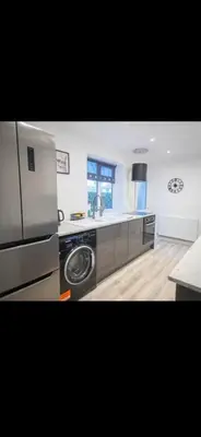 a large kitchen with a washer and dryer in it at Comfortable Carlisle Stay with Free Parking in Carlisle
