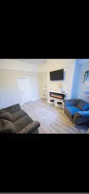 a living room with a couch and a television at Comfortable Carlisle Stay with Free Parking in Carlisle
