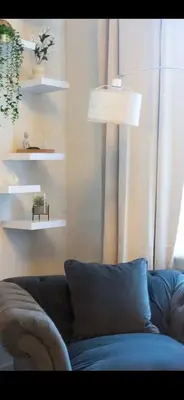 a living room with a couch and a lamp at Comfortable Carlisle Stay with Free Parking in Carlisle