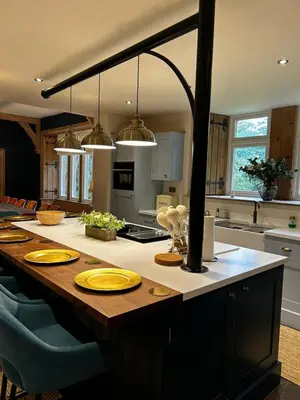 a kitchen with a large table with yellow plates on it at The Old Vicarage Irton in Parton