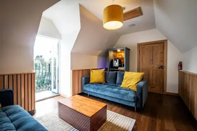 a living room with a couch and a table at The Old Vicarage Irton in Parton