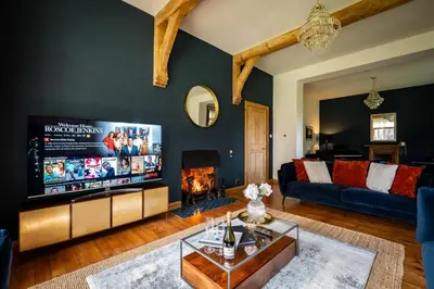 a living room with a large flat screen tv at The Old Vicarage Irton in Parton