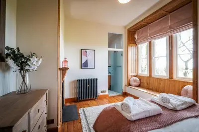 a bedroom with two white towels on a bed at The Old Vicarage Irton in Parton