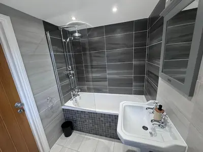 a bathroom with a bath tub and a sink at Granville Road, near Hospital, sleeps 5 in Carlisle
