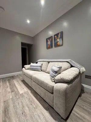 a living room with a large couch in a room at Granville Road, near Hospital, sleeps 5 in Carlisle
