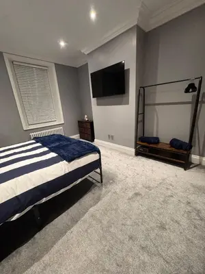 a bedroom with a bed and a flat screen tv at Granville Road, near Hospital, sleeps 5 in Carlisle