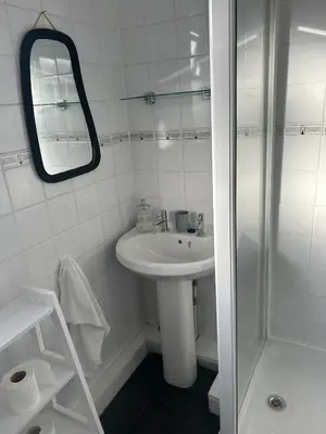 a white bathroom with a sink and a shower at Rochester Cosy Comfort near Shops and Restaurant in Moffat