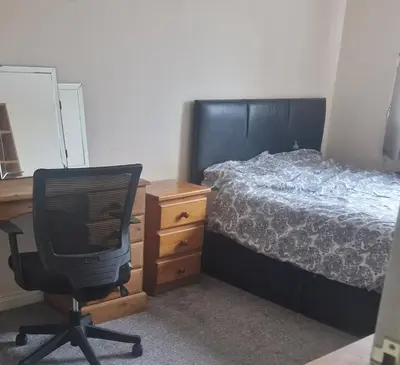a bedroom with a bed and a desk and a chair at Victory Room in Moffat
