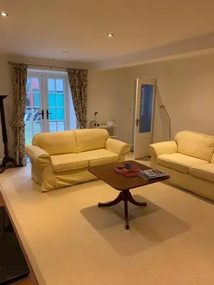 a living room with two couches and a coffee table at Bee Cottage in Moffat