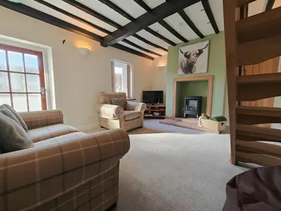 a living room with a couch and a fireplace at 4 Bed in Ireby oc-p34997 in Ireby