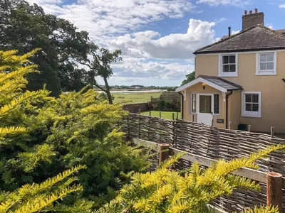 a house with a fence in front of a field at Solway Marsh View - Uk1553 in Rockcliffe