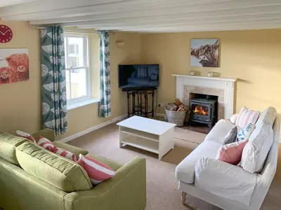 a living room with two couches and a fireplace at Solway Marsh View - Uk1553 in Rockcliffe
