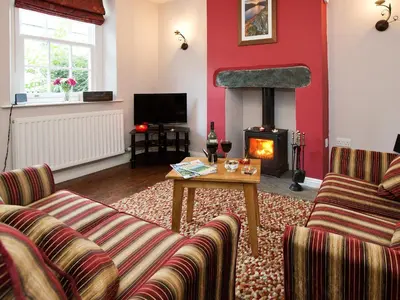 a living room with two couches and a fireplace at 22 Rose Terrace in Keswick