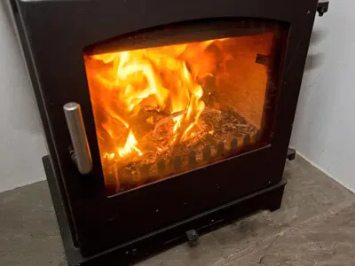 a fireplace with a fire in it at 22 Rose Terrace in Keswick