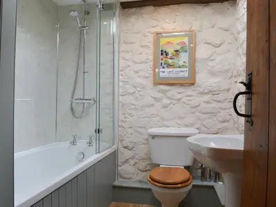 a bathroom with a toilet and a sink and a shower at Branthwaite Stable in Caldbeck