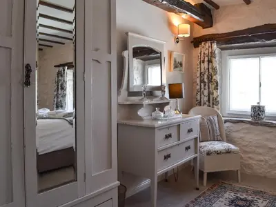 a bedroom with a dressing table and a mirror at Branthwaite Stable in Caldbeck