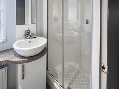 a bathroom with a sink and a glass shower at The View in Stranraer