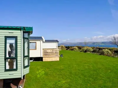 a house in a field with a green yard at The View in Stranraer